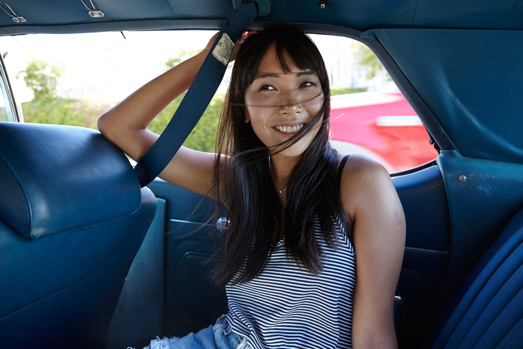 Lifestyle_Photographer_Edgy_Young_Woman_Asian_Millennial_Levis_Advertising_Los_Angeles_Chicago_Mexico_City_Girl_in_Back_Seat_Car_Auto_Wind_Blowing_Hair_Asian_Millennial_Chicago_Photographer_Mike_Henry